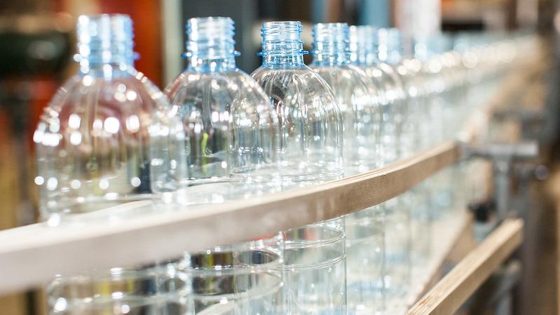 Row of PET bottles on conveyor belt