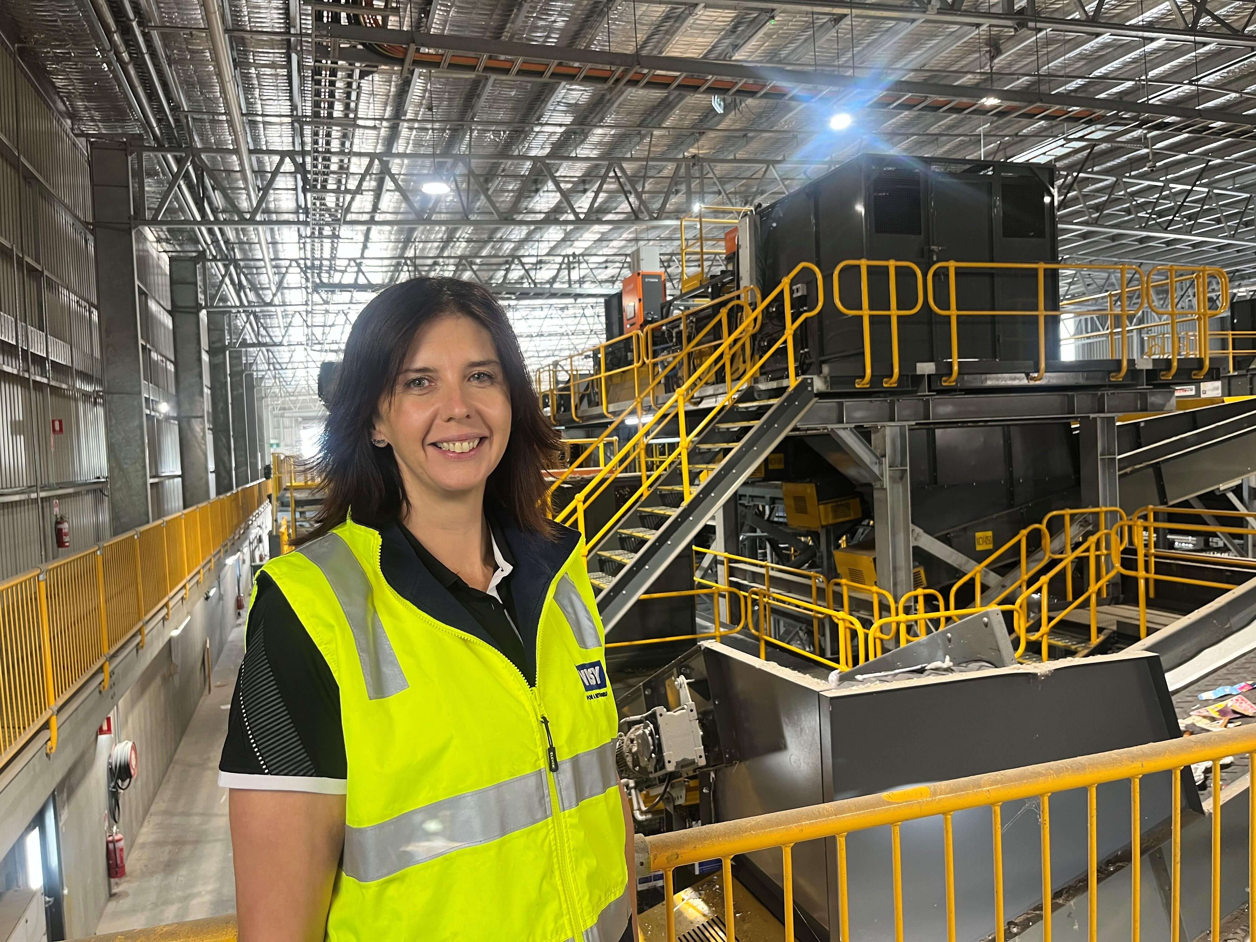 Women standing in front of recycling facility