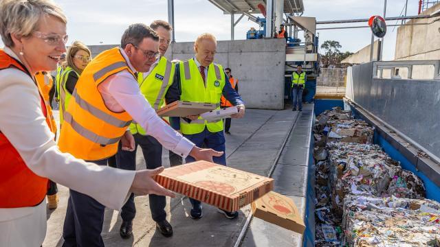 People throwing pizza boxes into recycling stream