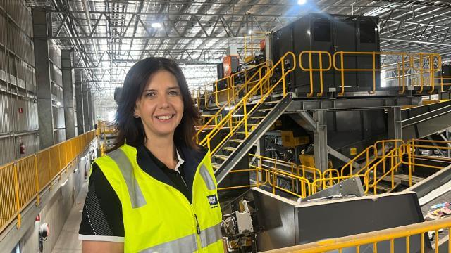 Women standing in front of recycling facility
