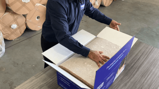 A man closing the lid on a box