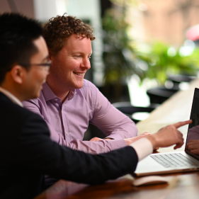 Two men looking at screen