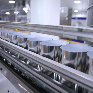 A row of aluminium cans in a manufacturing facility