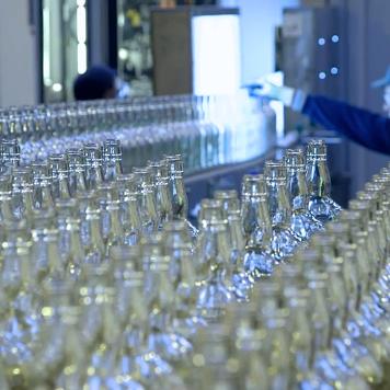 Rows of clear glass bottles
