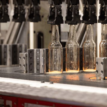 Four glass bottles come off the production line at Yatala, Queensland.